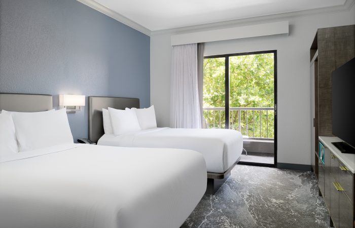 two double beds looking out to the trees
