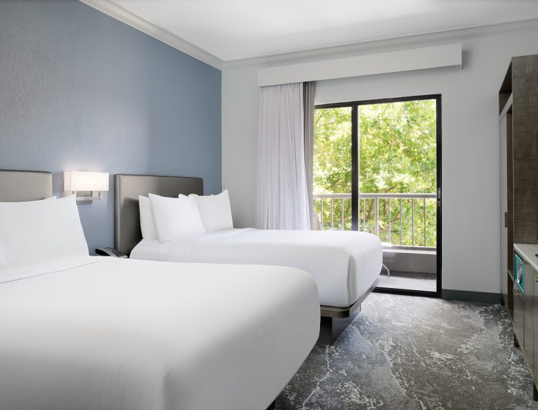 two double beds looking out to the trees