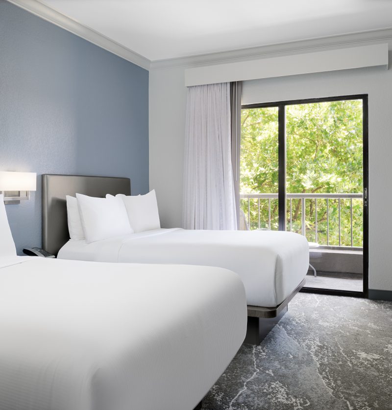 two double beds looking out to the trees